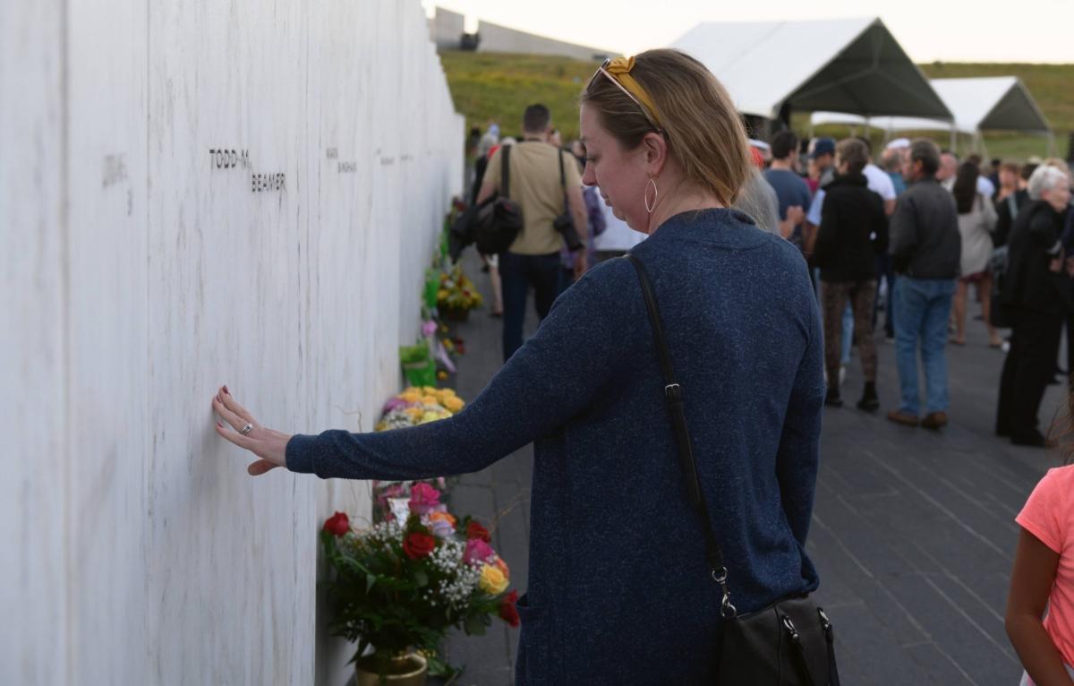 Jennilee Miller pays respect to victim Todd Beamer at the Wall of Names at the Flight 93 National Monument before the Luminaria Ceremony in Shanksville, Pa., on Sept. 10, 2021. (Jeff Swensen/Getty Images)