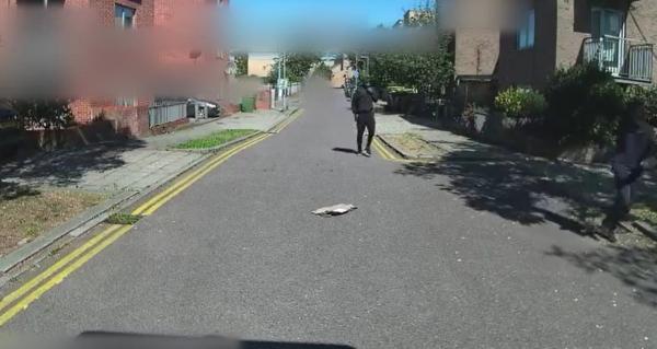 A video grab of two men in dark clothing seen running away from the scene of the murder of Ronaldo 'Skengroy' Scott in Brixton, London, on Sep. 4, 2023. (Metropolitan Police)
