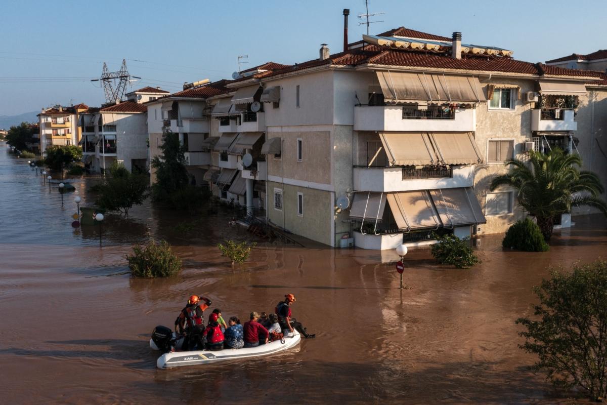 Residents are rescued by boats from their flooded houses in the workers' housing in Giannouli, Larissa, on Sept. 9, 2023. (Konstantinos Tsakalidis/SOOC/AFP via Getty Images)