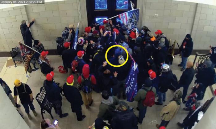 Leo Brent Bozell IV (in yellow circle) is among the crowd who helped push open the inner entrance from the Columbus Doors at the U.S. Capitol on Jan. 6, 2021. (U.S. Department of Justice/Screenshot via The Epoch Times)