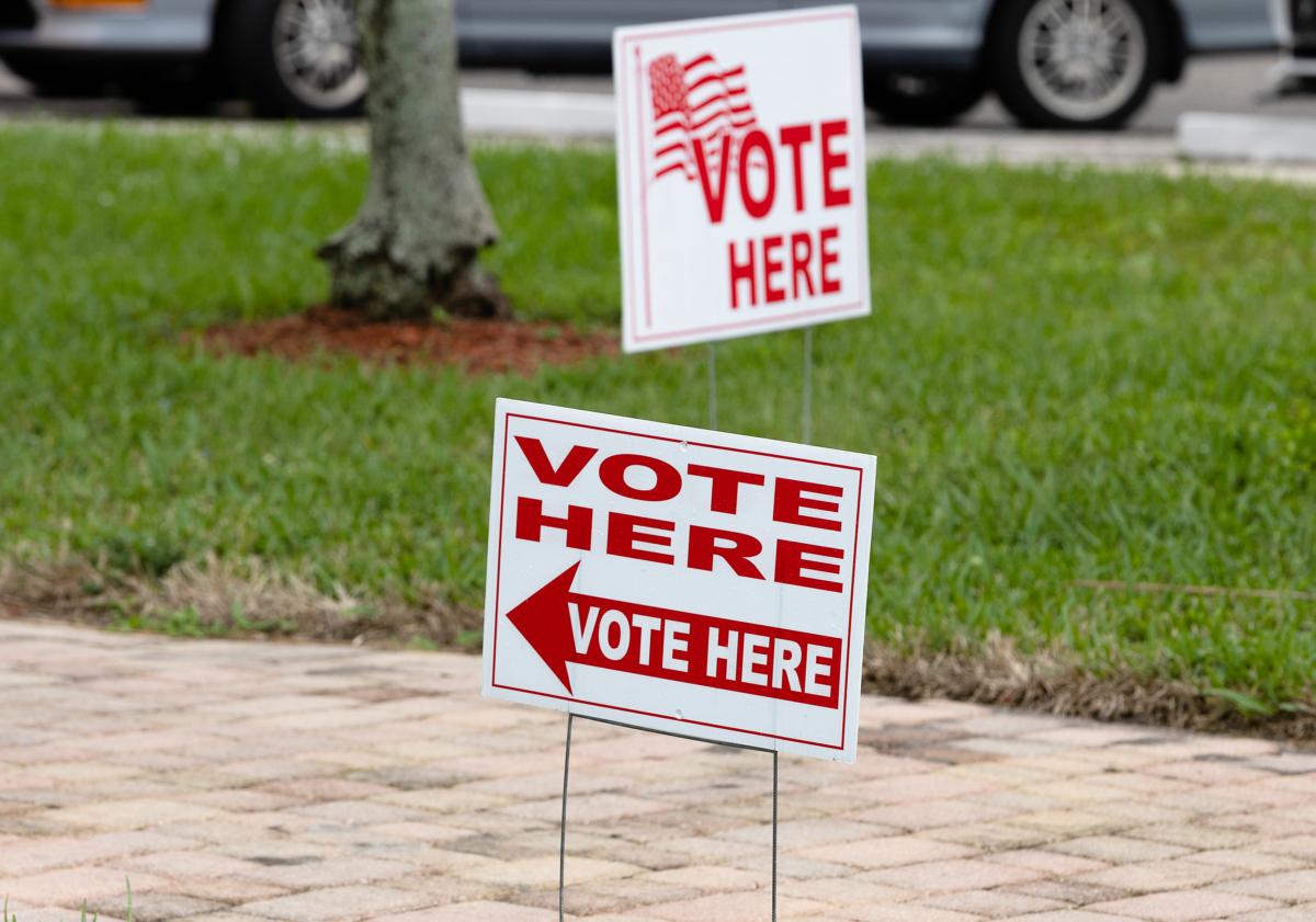 Signs outside of a polling station during the election for the 20th Congressional District in Lauderhill, Fla., on Jan. 11, 2022. (Joe Raedle/Getty Images)