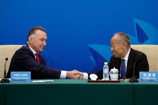 Australia's former trade minister, Craig Emerson, and China's former foreign minister, Li Zhaoxing, shake hands at the 7th China-Australia High Level Dialogue at the Diaoyutai State Guesthouse in Beijing on Sept. 7, 2023. (Florence Lo/POOL/AFP via Getty Images)