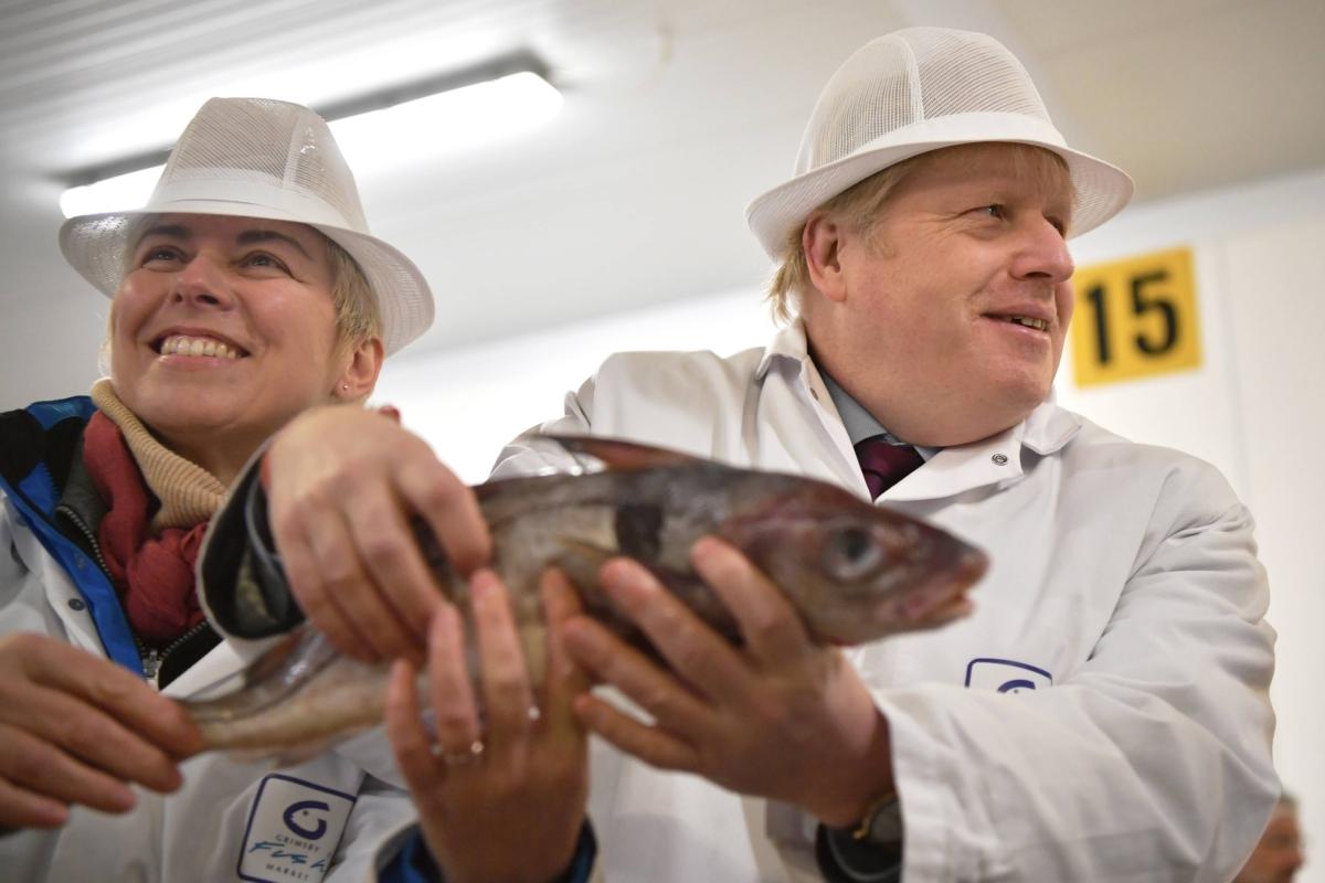 Conservative candidate for Great Grimsby Lia Nici (L) poses with Prime Minister Boris Johnson during a general election campaign visit to Grimsby Fish Market, United Kingdom, on Dec. 9, 2019. (Ben Stansall – WPA Pool/Getty Images)