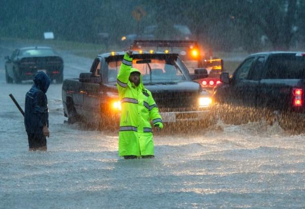 Vehicles make their way through a flooded Lancaster Street during heavy rain in Leominster, Mass., on Sept. 11, 2023. (Rick Cinclair/Worcester Telegram & Gazette via AP)