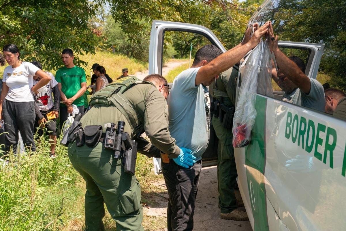  A migrant who has crossed into the U.S. from Mexico in Eagle Pass, Texas, gets frisked by a Border Patrol Agent on Aug. 25, 2023. (Suzanne Cordeiro/AFP via Getty Images)