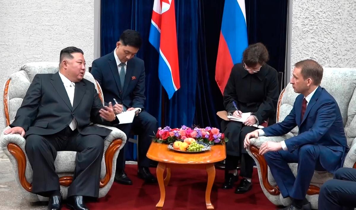 North Korean leader Kim Jong Un (L) gestures as he speaks to Russian Minister of Natural Resources and Ecology Alexander Kozlov (R) in Khasan, about 127 kilometers (79 miles) south of Vladivostok, Russia, in a still from video released on Sept. 12, 2023. (Governor of the Russian far eastern region of Primorsky Krai Oleg Kozhemyako telegram channel via AP)