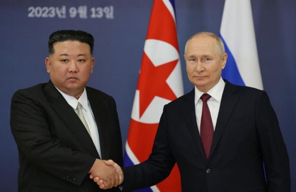 Russian President Vladimir Putin (R) and North Korean leader Kim Jong Un (L) shaking hands during their meeting at the Vostochny Cosmodrome in Russia's Amur region on Sept. 13, 2023, ahead of planned talks that could lead to a weapons deal with the Russian president. (Vladimir Smirnov/POOL/AFP via Getty Images)