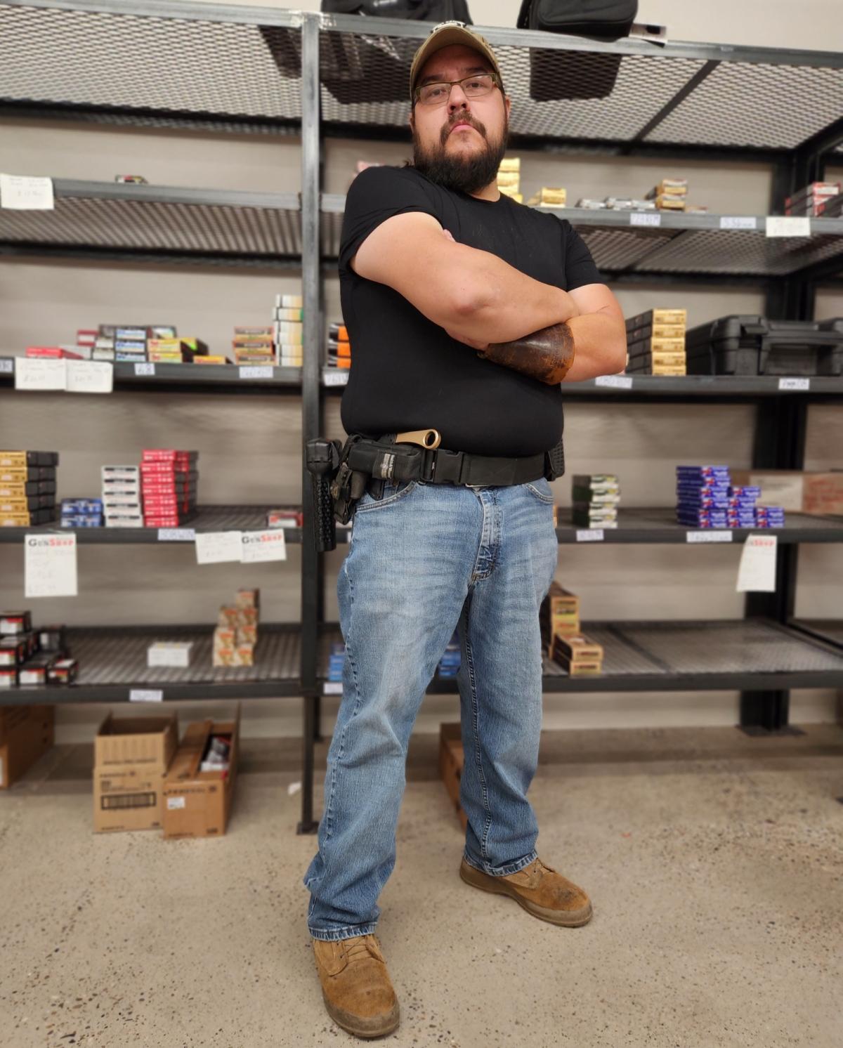 Luke Saiz of Albuquerque, N.M., holstering a Glock 9mm semi-autoamtic handgun, said he will continue carrying firearms in public in defiance of a public health order by New Mexico Gov. Michelle Lujan Grisham. Photo taken on Sept. 12, 2023. (Allan Stein/The Epoch Times)
