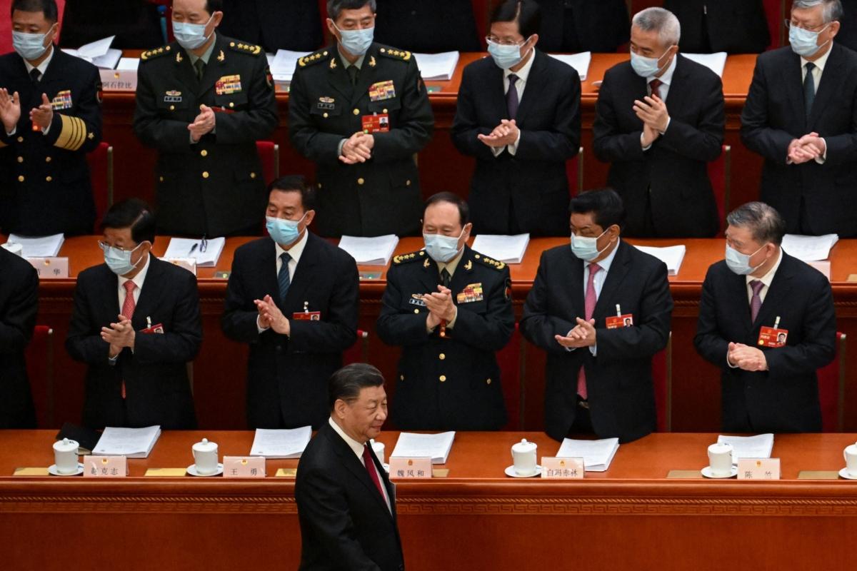  Delegates, including China's Defence Minister Wei Fenghe (3rd L), applaud as China's leader Xi Jinping (bottom) arrives for the opening session of the National People's Congress (NPC) at the Great Hall of the People in Beijing on March 5, 2023. (Noel Celis /AFP via Getty Images)
