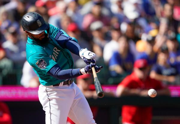 Seattle Mariners' Teoscar Hernandez hits a single to score Julio Rodriguez against the Los Angeles Angels during the fifth inning of a baseball game in Seattle on Sept. 13, 2023. (Lindsey Wasson/AP Photo)