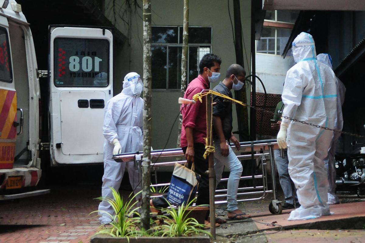 Health workers wearing protective gear shift people who have been in contact with a person infected with the Nipah virus to an isolation center at a government hospital in Kozhikode, Kerala, India, on Sept. 14, 2023. (AFP via Getty Images)
