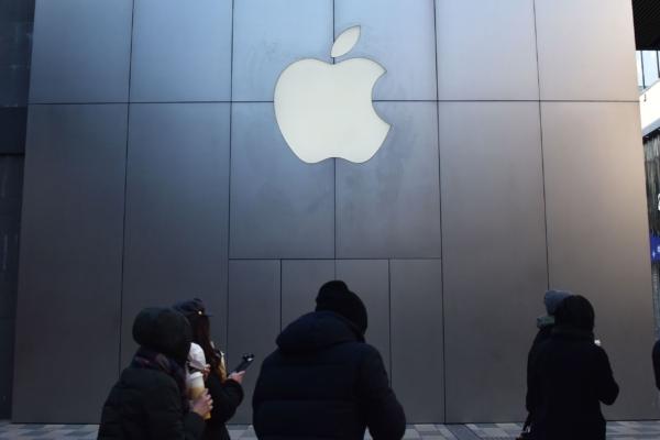 People walk past an Apple store in Beijing, on Dec. 11, 2018. (Greg Baker/AFP via Getty Images)