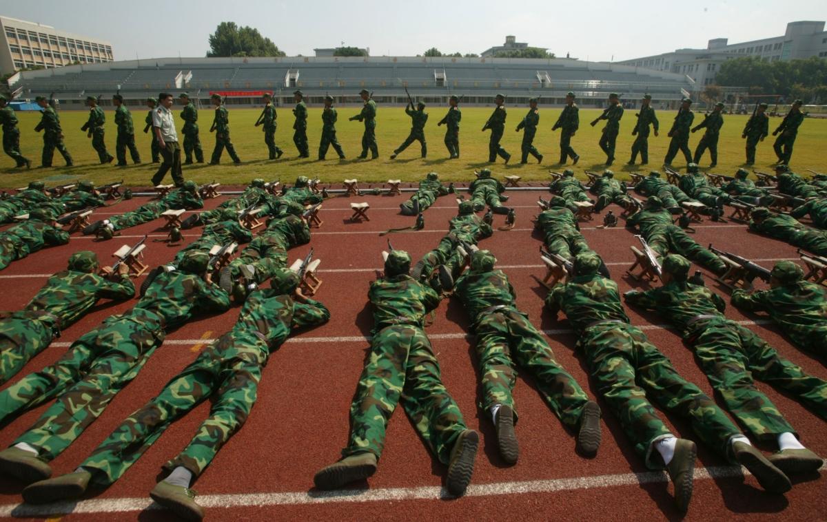 Freshmen from the Nanjing University of Science and Technology practice shooting skills during a military training session in Nanjing of Jiangsu Province, China on Sept. 11, 2007. (China Photos/Getty Images)