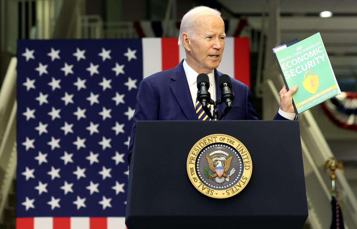 U.S. President Joe Biden holds up a copy of the Republican's FY2024 budget as he delivers remarks at Prince George's Community College in Largo, Md., on Sept. 14, 2023. (Kevin Dietsch/Getty Images)