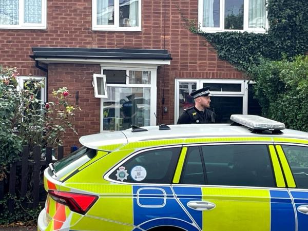 A police officer outside a house where a man was fatally attacked by a dog in Stonnall, Staffordshire, on Sep. 15, 2023. (PA)