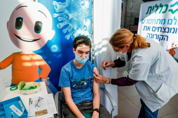A teenager receives a dose of the Pfizer-BioNtech COVID-19 vaccine at Clalit Health Services in Tel Aviv, Israel, on Jan. 23, 2021. (Jack Guez/AFP via Getty Images)
