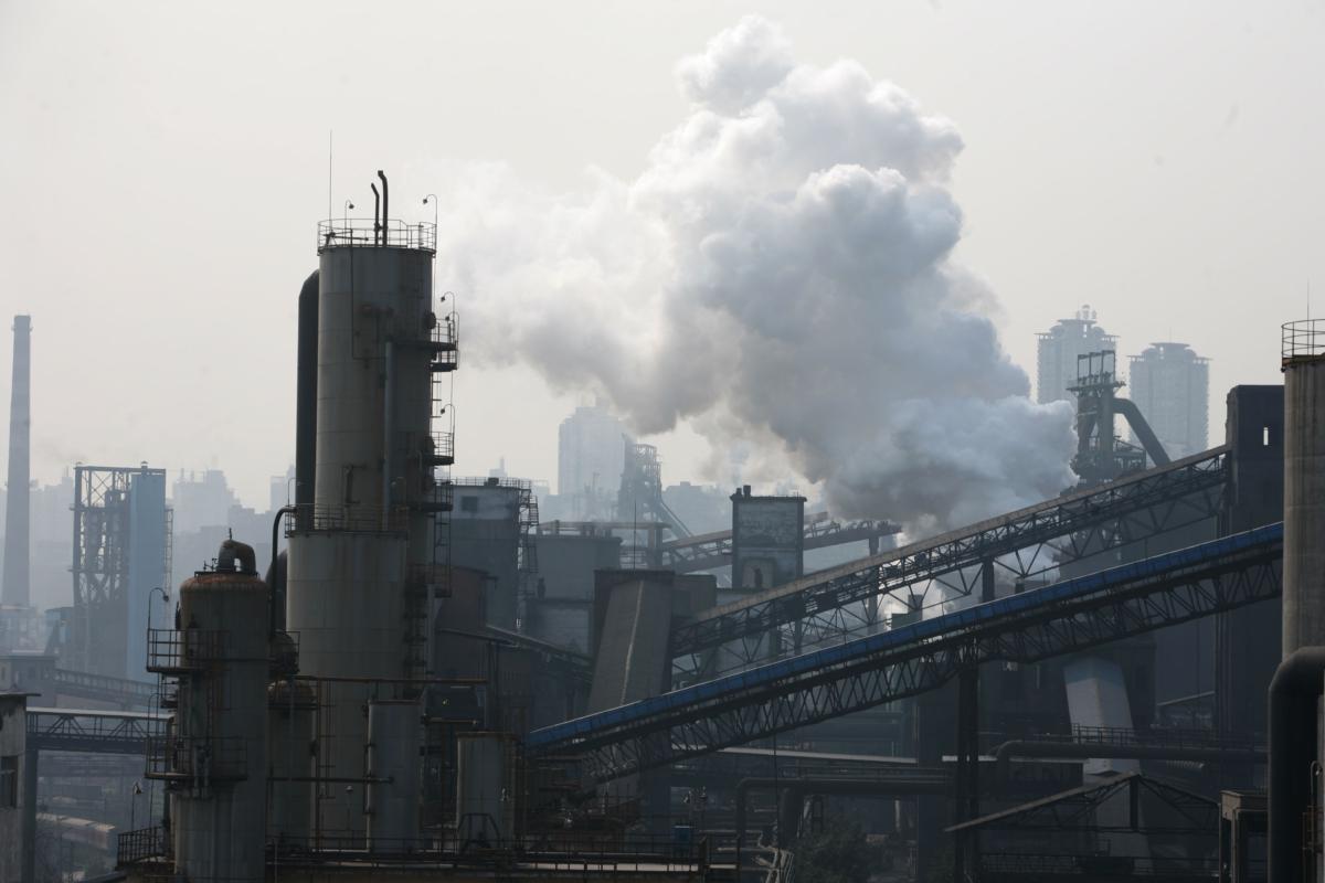 Smoke billows from steel slags at a Chongqing Iron and Steel Group plant, in Chongqing, China, on March 1, 2007. (China Photos/Getty Images)