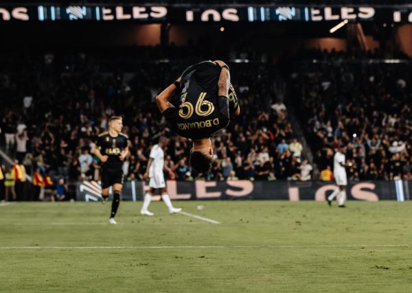 Los Angeles FC forward Denis Bouanga (99) flips in celebration of his first goal against the Los Angeles Galaxy at BMO Stadium in Los Angeles on Sept. 16, 2023. (Courtesy of LAFC via The Epoch Times).