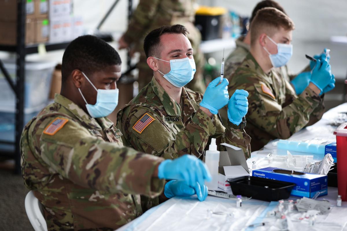 U.S. Army soldiers prepare Pfizer COVID-19 vaccines at the Miami Dade College North Campus in North Miami on March 9, 2021. (Joe Raedle/Getty Images)