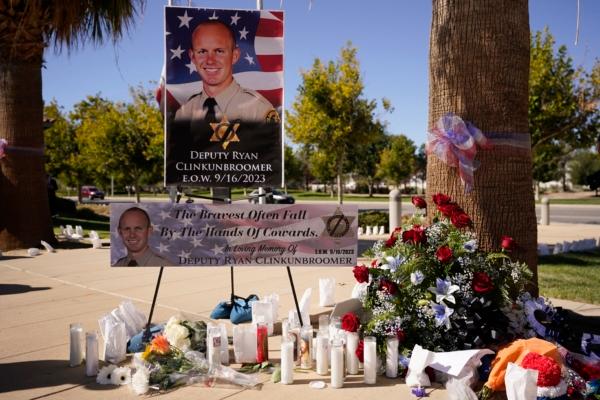  A shrine to honor deputy Ryan Clinkunbroomer is placed outside of the Palmdale Sheriff's Station during a press to announce an arrest in the ambush killing of the Los Angeles County sheriff's deputy, in Palmdale, Calif., on Sept. 18, 2023. (Marcio Jose Sanchez/AP Photo)