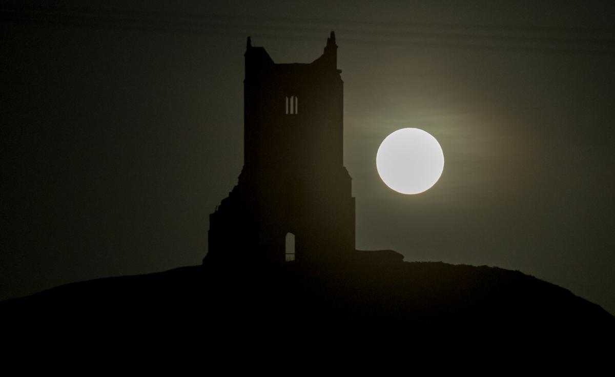 The full Harvest Moon rises over the ruins of St. Michael's Church, a scheduled monument on the top of Burrow Mump on Oct. 5, 2017, in Somerset, England. (Matt Cardy/Getty Images)