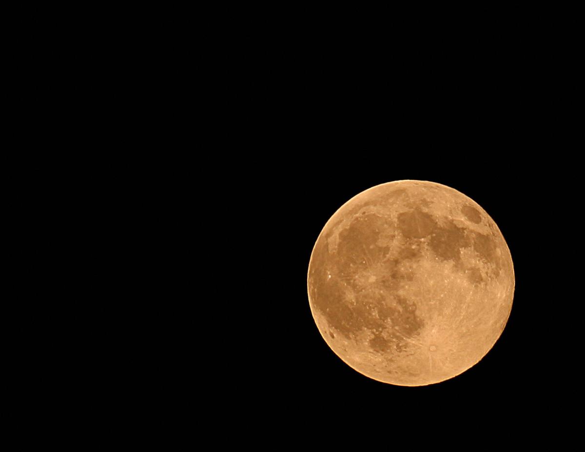 An orange "Harvest Moon" rises over Manassas, Virginia, on Sept. 26, 2007. (KAREN BLEIER/AFP via Getty Images)