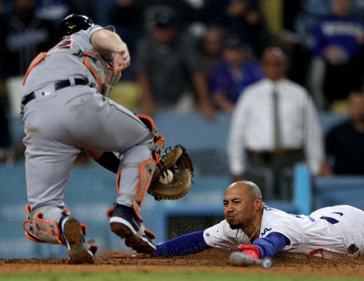 Mookie Betts (50) of the Los Angeles Dodgers reacts as he slides under the tag from Jake Rogers (34) of the Detroit Tigers, to score the game winning run for a 3–2 win during the ninth inning at Dodger Stadium in Los Angeles on Sept. 19, 2023. (Harry How/Getty Images)