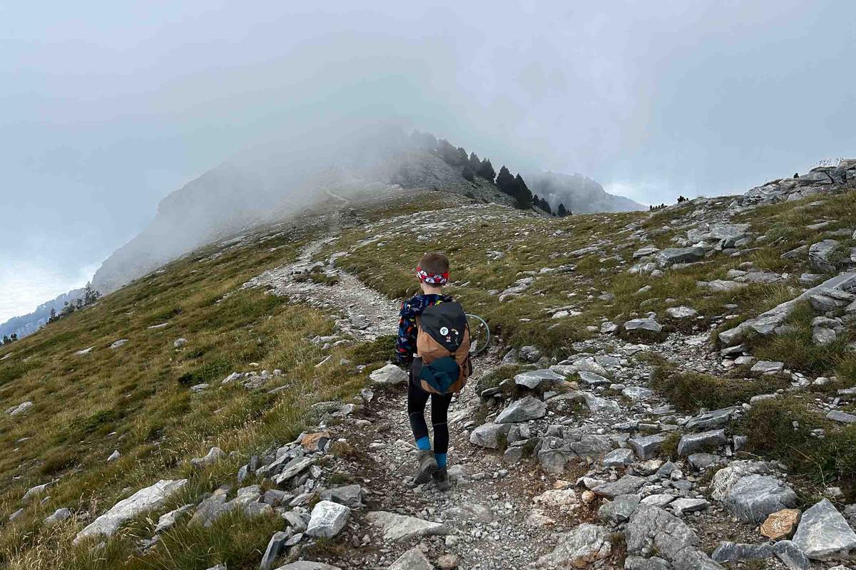 Frankie McMillan, 7, hikes up a rocky ridge shrouded in mist. (SWNS)