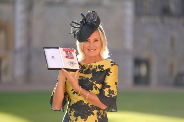 Dame Caroline Dinenage, MP for Gosport, holds her Dame Commander of the British Empire medal presented to her by the Princess Royal during an investiture ceremony at Windsor Castle, Berkshire, on Oct. 18, 2022. (Andrew Matthews/PA Wire)