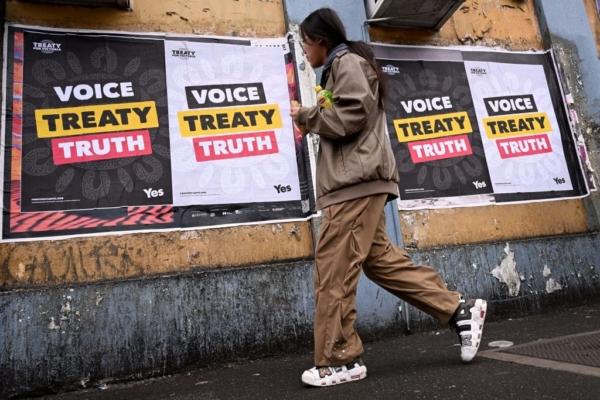A woman walks past posters advocating for an Aboriginal voice and treaty ahead of an upcoming referendum in Melbourne, Australia, on Aug. 30, 2023. (William West/AFP via Getty Images)