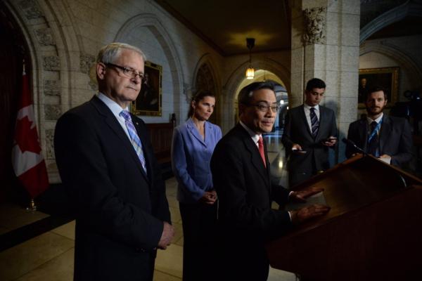 Liberal MPs Ted Hsu, right, holds a press conference in the foyer of the House of Commons on Parliament Hill in Ottawa on May 26, 2015. (Sean Kilpatrick/The Canadian Press)