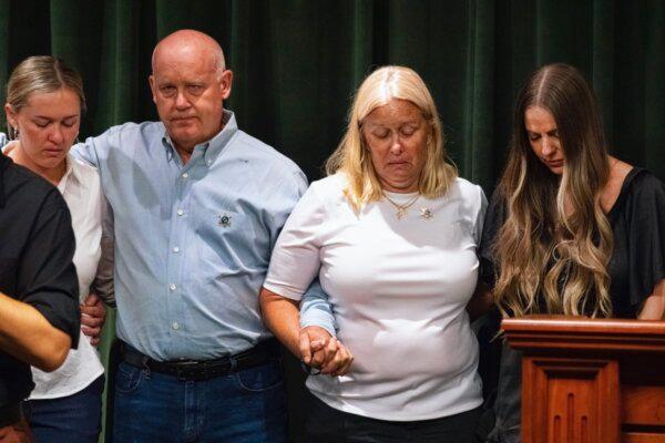 Sheriff's deputy Ryan Clinkunbroomer's parents clasp arms with his fiancee Brittany Lindsey (R) during a news conference at the Hall of Justice in downtown Los Angeles on Sept. 20, 2023. (Richard Vogel/AP Photo)