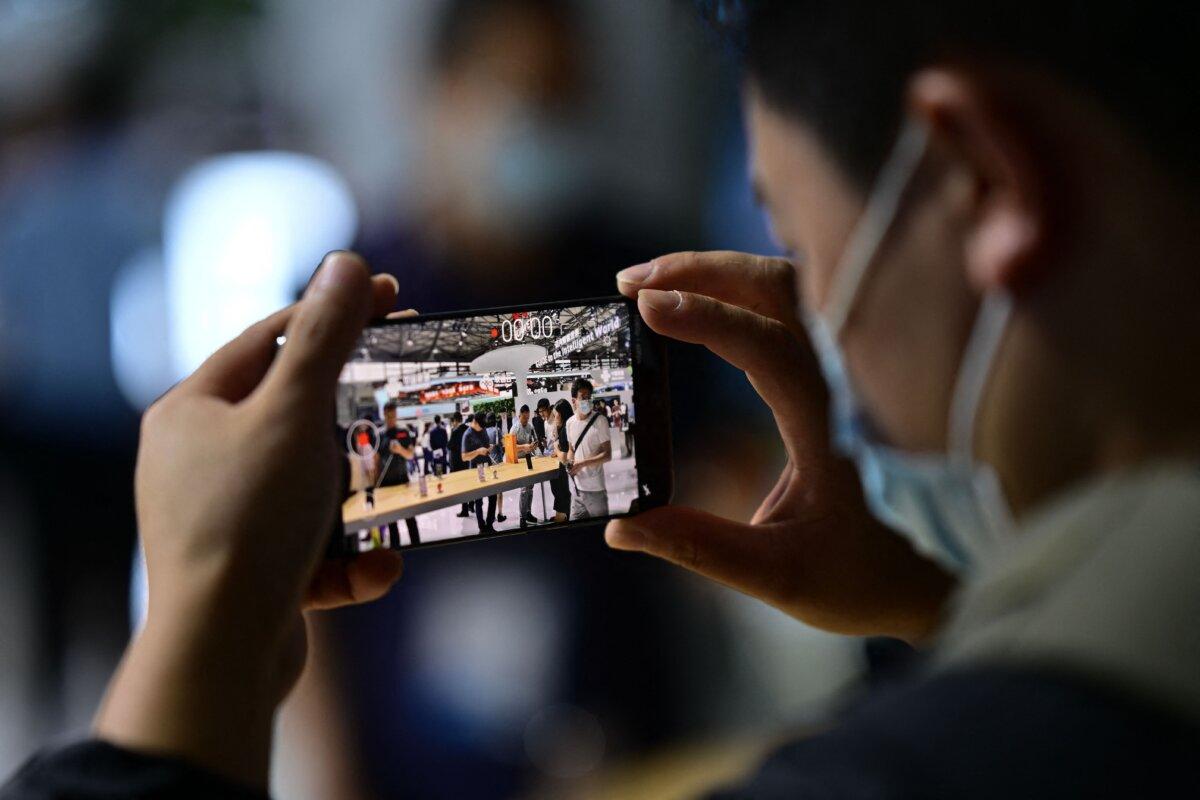 A man tests a Huawei smartphone at the Mobile World Congress in Shanghai on June 28, 2023. (Pedro Pardo/AFP via Getty Images)