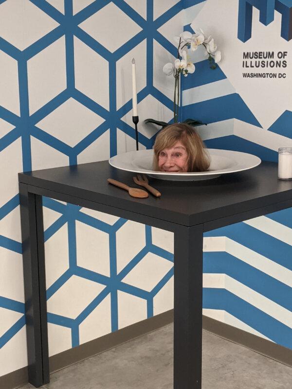 A visitor to the Museum of Illusions in Washington, D.C., appears to have her head served up on a platter. (Photo courtesy of Elle Kendall.)