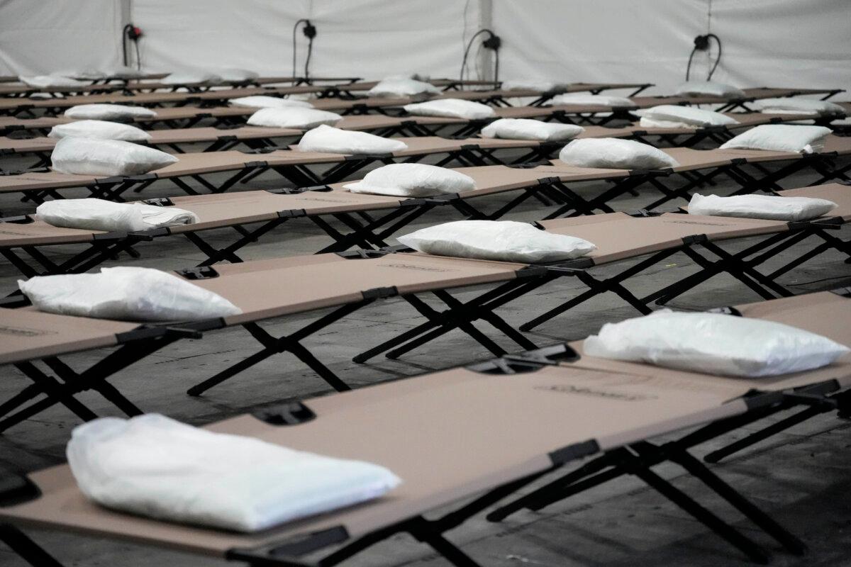 Bags containing a pillow, towel, and bed sheets are placed on cots inside a tent shelter that could house up to 1,000 illegal migrants in the Queens borough of New York on Aug. 15, 2023. (Mary Altaffer/AP Photo)