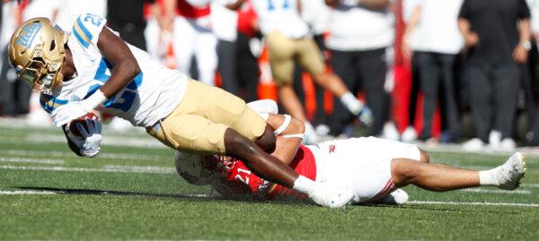 Karene Reid (21) of the Utah Utes tackles Ezavier Staples (25) of the UCLA Bruins during the second half of their game at Rice-Eccles Stadium in Salt Lake City on Sept. 23, 2023. (Chris Gardner/Getty Images)