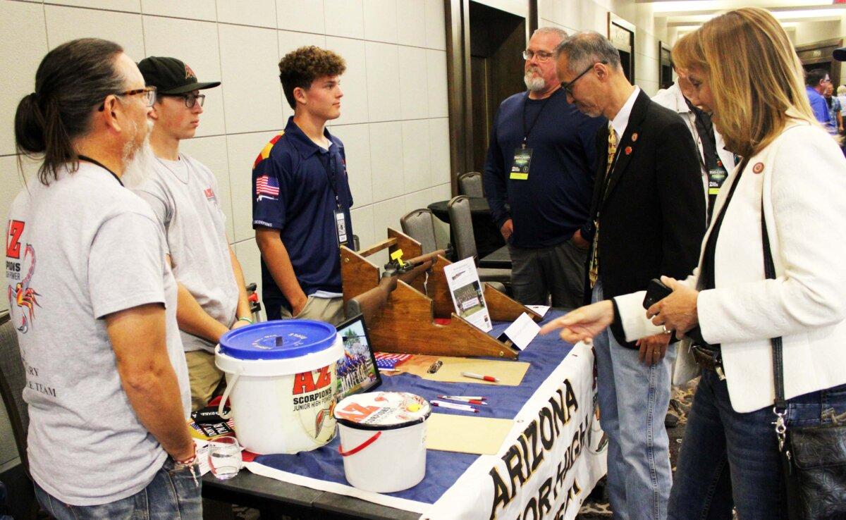 Members of the Arizona Junior High Power competition shooting team speak to attendees of the 38th Gun Rights Policy Conference in Phoenix, Ariz., on Sept. 23, 2023. (Michael Clements/The Epoch Times)