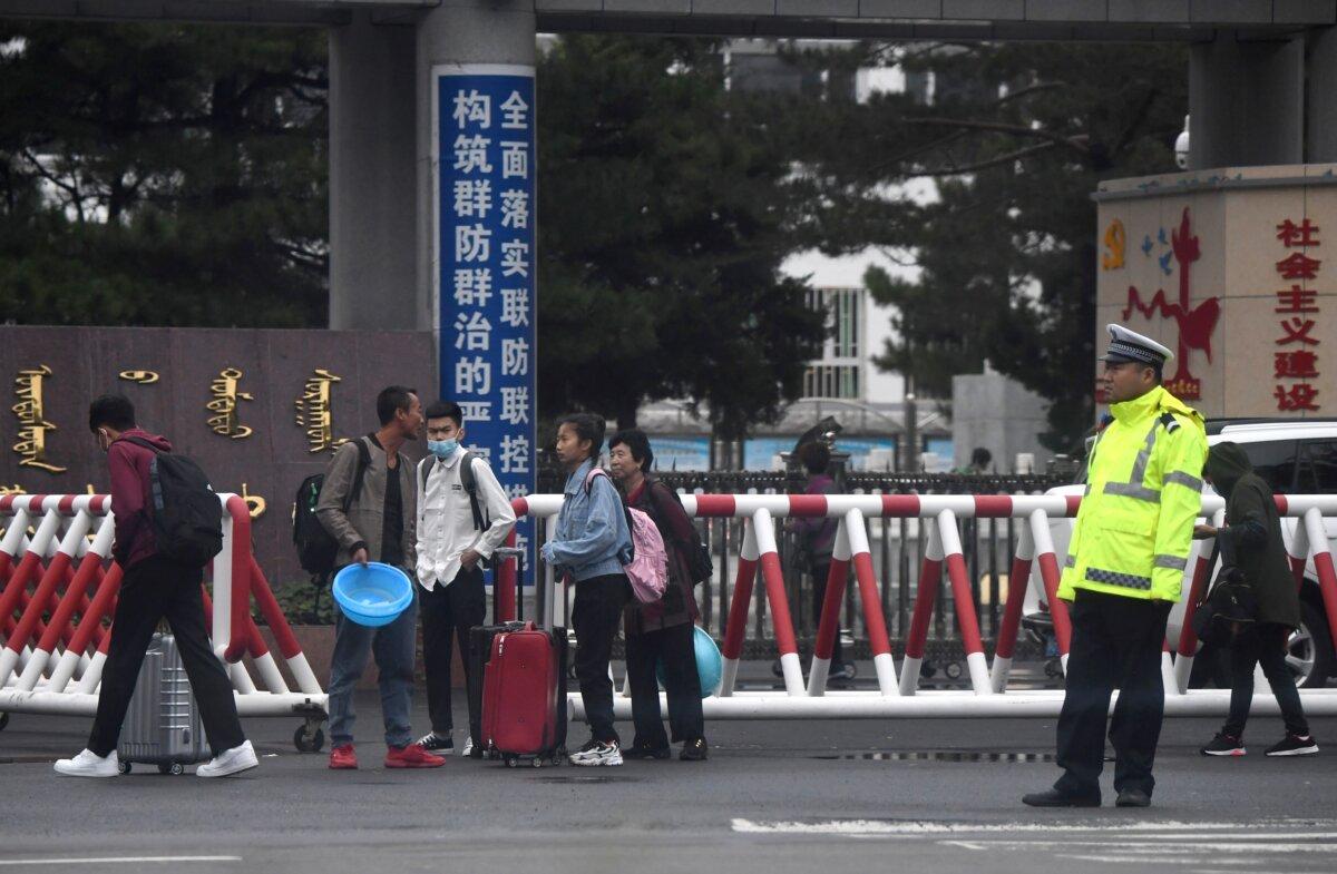Parents wait outside a school in Tongliao, China's northern Inner Mongolia region, on Sept. 10, 2020. (Noel Celis/AFP via Getty Images)
