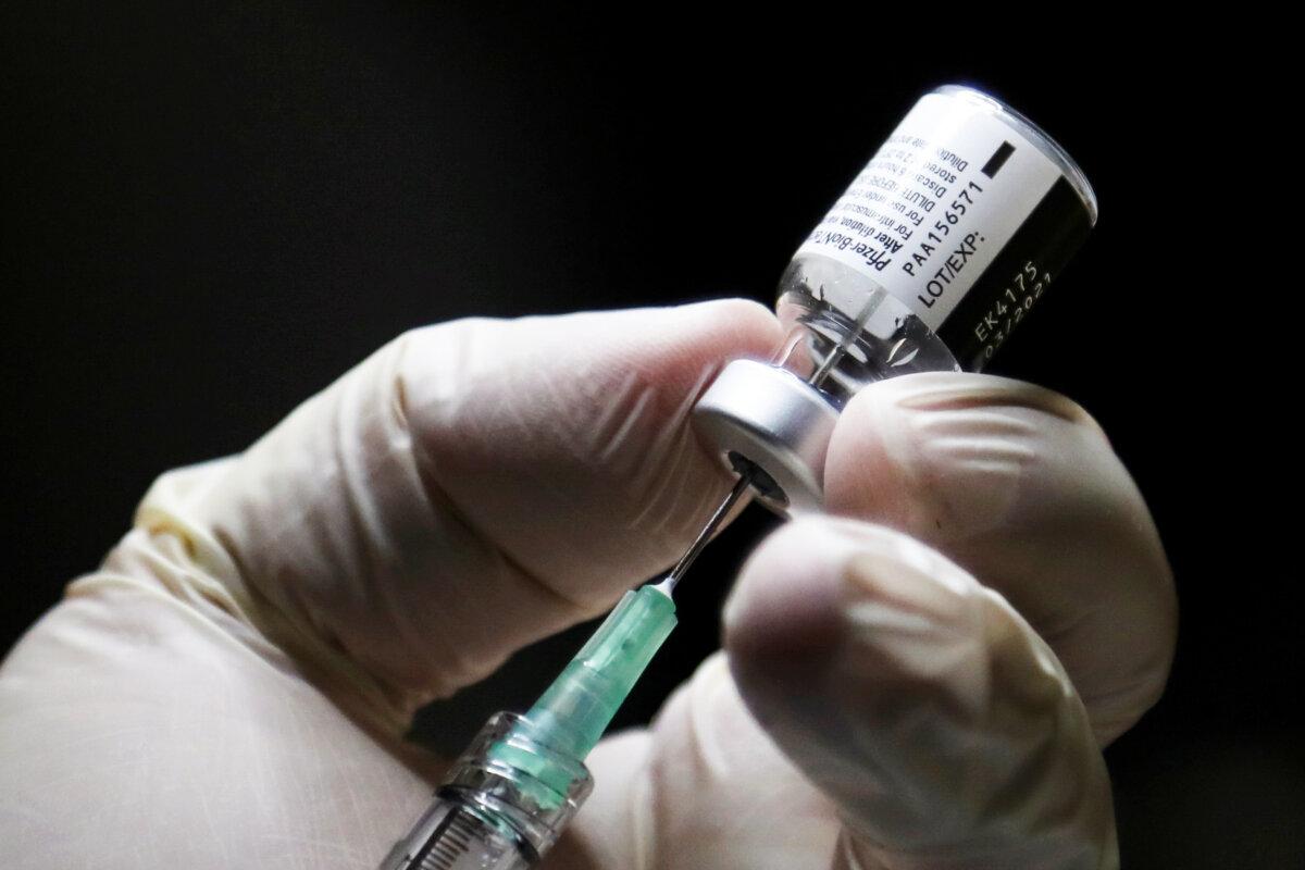 A health care worker prepares a dose Pfizer/BioNTEch COVID-19 vaccine at The Michener Institute, in Toronto, Canada, on Dec.14, 2020. (Carlos Osorio/POOL/AFP via Getty Images)