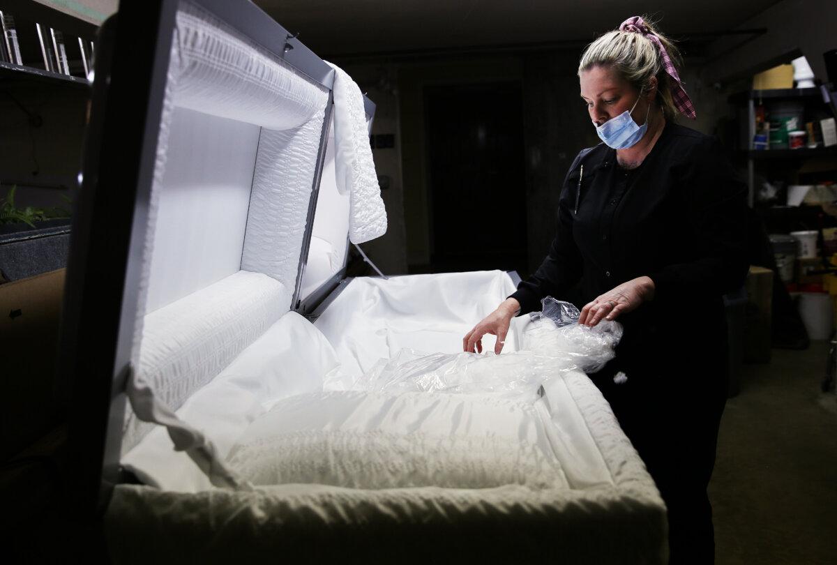 An embalmer prepares a casket at East County Mortuary in El Cajon, Calif., on Jan. 15, 2021. (Mario Tama/Getty Images)