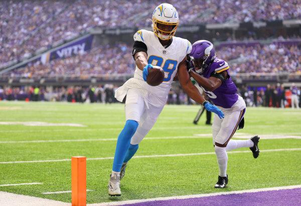  Donald Parham Jr. (89) of the Los Angeles Chargers runs past Mekhi Blackmon (5) of the Minnesota Vikings while scoring a touchdown during the first quarter at U.S. Bank Stadium in Minneapolis on Sept. 24, 2023. (Adam Bettcher/Getty Images)