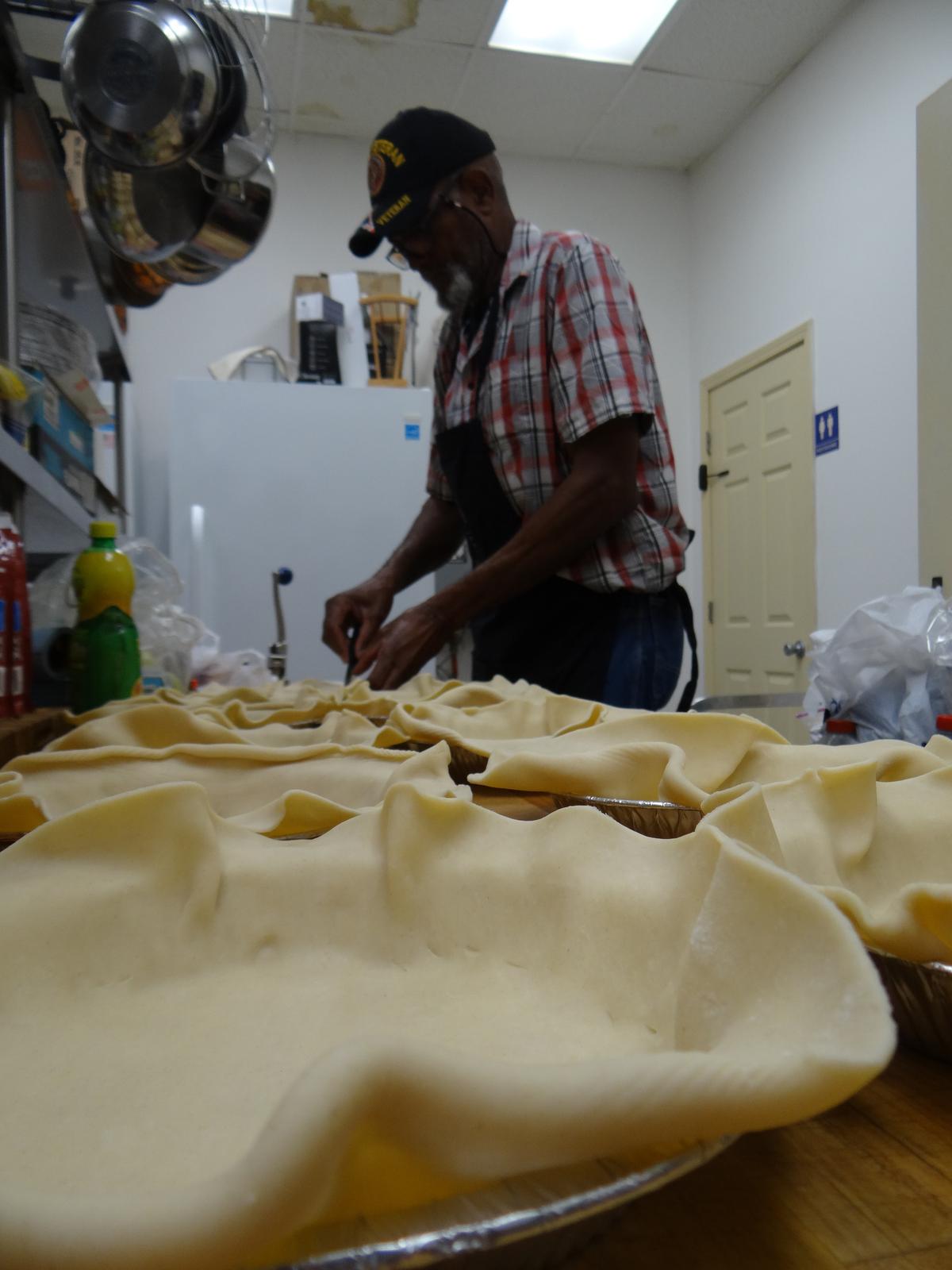 Freddie McMillan, a retired Marine master sergeant, prepares apple pies in the kitchen. (Randy Tatano)