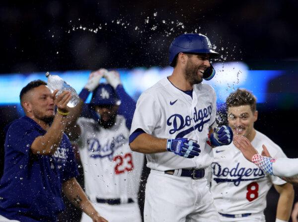 Chris Taylor (3) of the Los Angeles Dodgers celebrates his game winning single to score Amed Rosario (31) with Miguel Rojas (11), Jason Heyward (23) and Enrique Hernandez (8), for a win over the San Francisco Giants, during the tenth inning at Dodger Stadium in Los Angeles on Sept. 24, 2023. (Harry How/Getty Images)