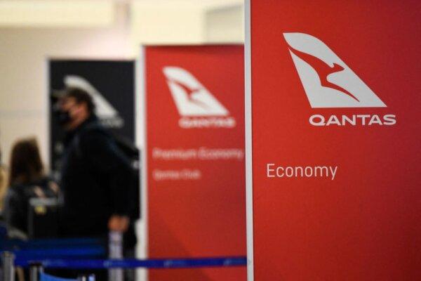 Travelers wait in line for a flight to Sydney, Australia on Qantas Airways Ltd. inside the Tom Bradley International Terminal at Los Angeles International Airport (LAX) on Nov. 1, 2021. (Patrick Fallon/AFP via Getty Images)