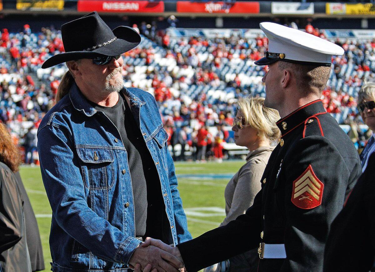 Mr. Adkins shakes hands with a Marine prior to a football game at the Nissan Stadium in Nashville, Tenn., 2019. (Frederick Breedon/Stringer/Getty Images Sport)