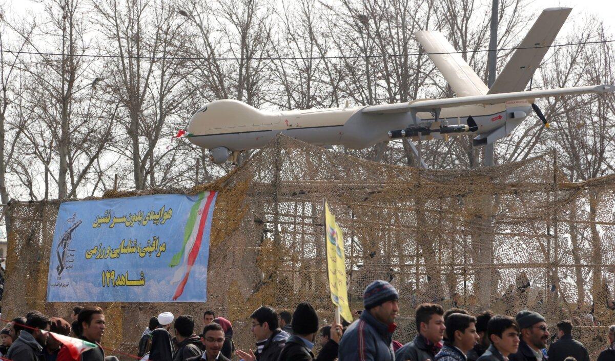Iranians walk past a Shahed 129 drone during celebrations in Tehran to mark the 37th anniversary of the Islamic Revolution on Feb. 11, 2016. (Atta Kenare/AFP via Getty Images)