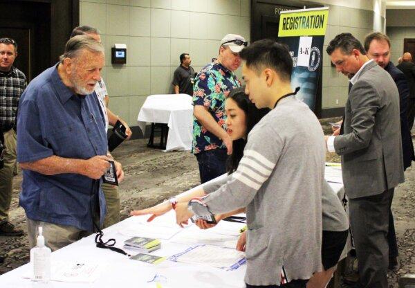 Volunteers help attendees register for the Gun Rights Policy Conference in Phoenix, Ariz., on Sept. 23, 2023. (Michael Clements/The Epoch Times)