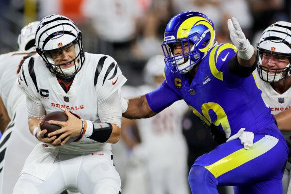 Aaron Donald (99) of the Los Angeles Rams sacks Joe Burrow (9) of the Cincinnati Bengals during the second quarter in the game at Paycor Stadium in Cincinnati on Sept. 25, 2023. (Andy Lyons/Getty Images)