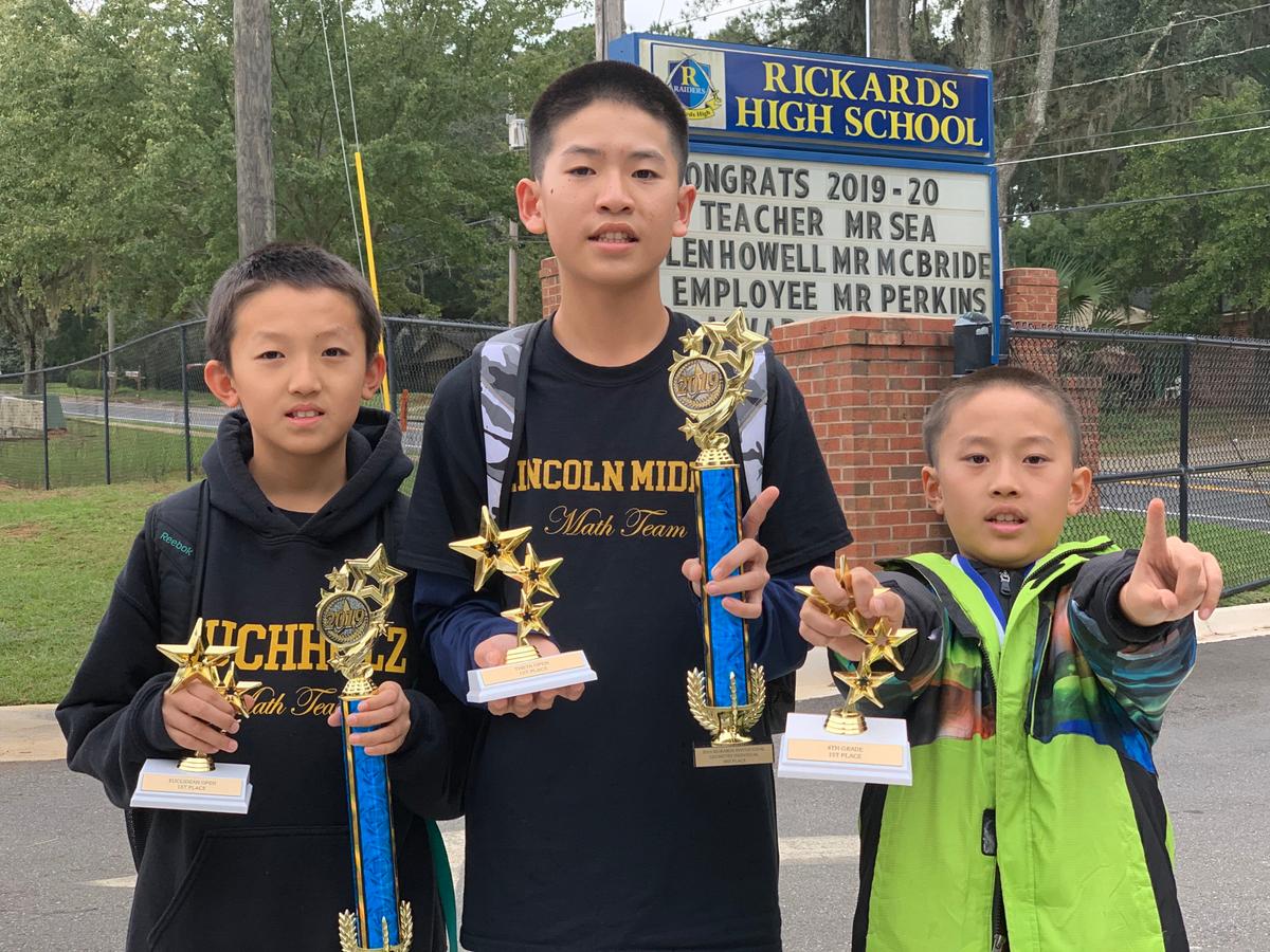 Michael Wei (L), Nathan Wei (2nd L), and Daniel Wei (R) at the Rickards Invitational in November 2019. (Courtesy of David Wei)