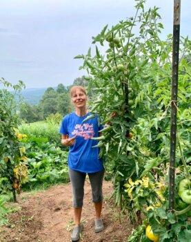 Hannelore Romeike stands with the tomato plant in her home garden in Tennessee in an undated photo. (Courtesy of Hannelore Romeike)